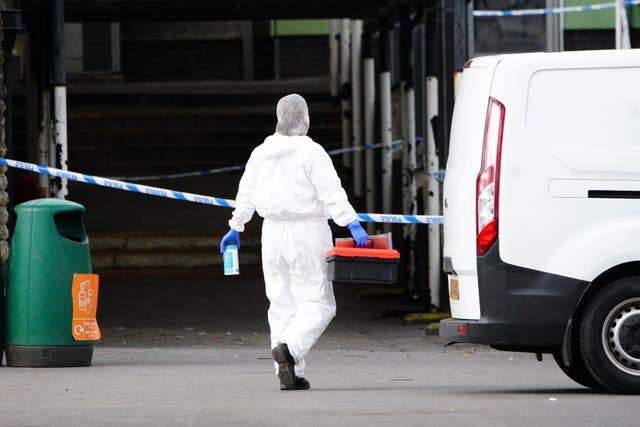 A person in a white forensic suit