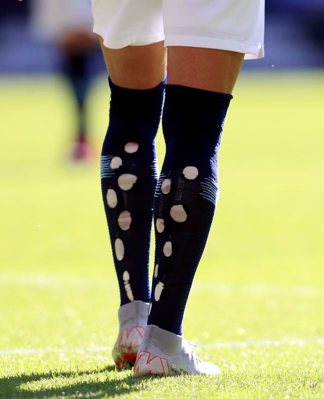 Why do some soccer players cut holes in their socks?