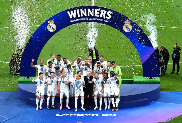 Real Madrid players lifting the Champions League trophy