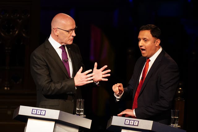 John Swinney and Anas Sarwar face each other during a debate