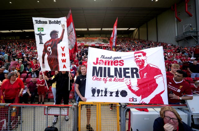 Liverpool fans hold up banners for Roberto Firmino and James Milner 