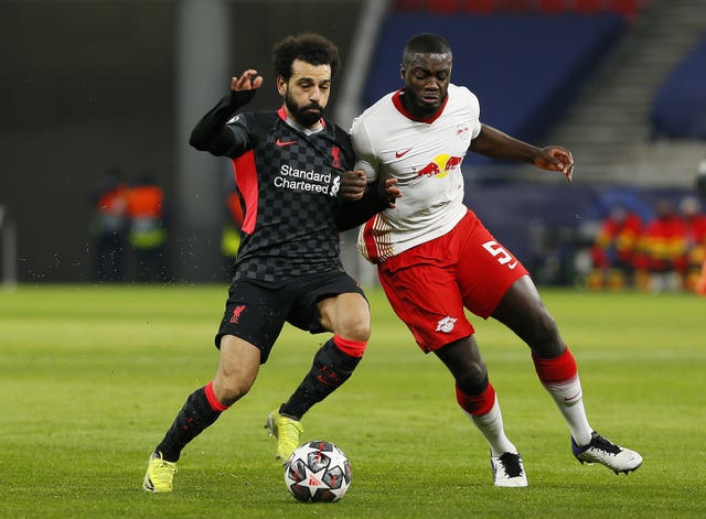 Liverpool’s Mohamed Salah and RB Leipzig’s Dayot Upamecano battle for the ball