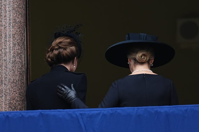 The Duchess of Edinburgh, right, puts her hand on the Princess of Wales's back as the pair leave the service