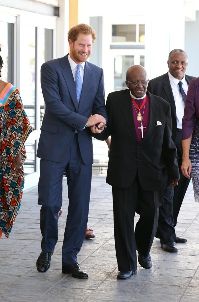 Prince Harry holding hands with the Archbishop Emeritus Desmond Tutu 