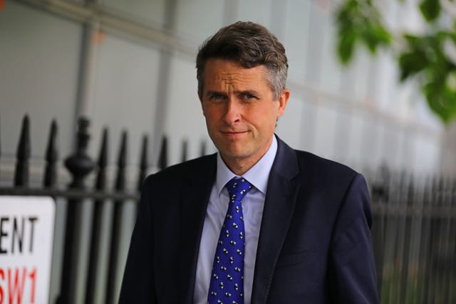 Conservative MP Sir Gavin Williamson walking down the street