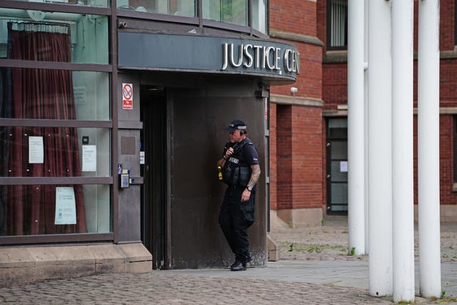 A police officer outside Nottingham Magistrates’ Court 