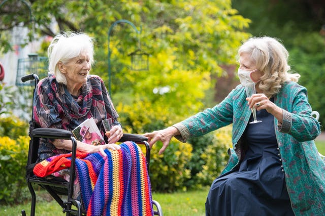 Judith du Vivier visits her 100-year-old mother Urania Brett for a surprise birthday party at the Compton Lodge care home in Camden in July 