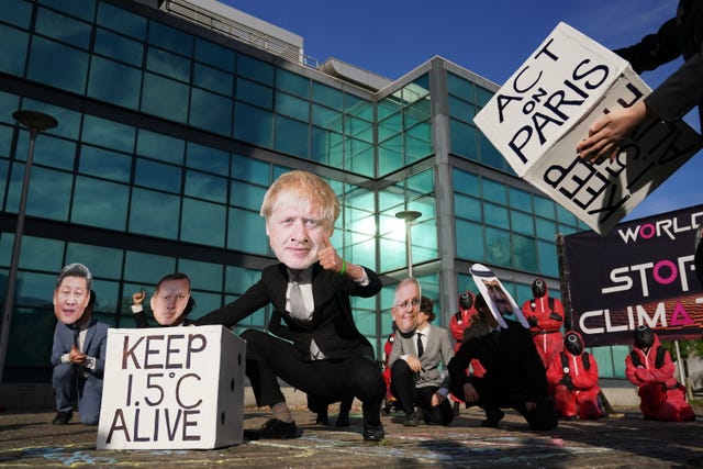 Protestor dressed as Boris Johnson played with dice at a Squid Game-themed protest