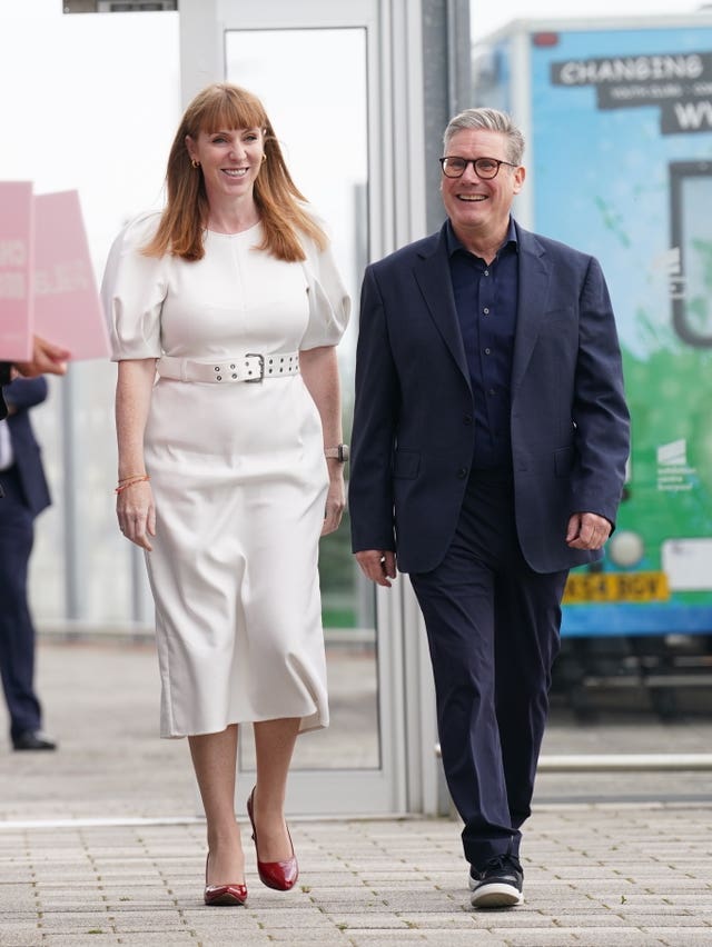 A woman in a white dress and a man in a dark suit