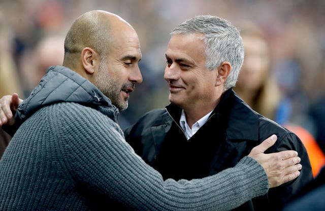 Pep Guardiola (left) and Jose Mourinho greet each other before a Manchester derby