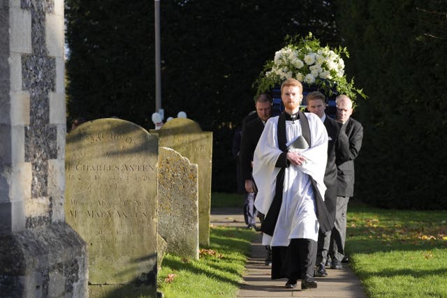 Liam Payne's coffin is carried past gravestones in a churchyard