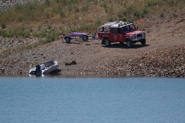 Personnel at Barragem do Arade reservoir, in the Algave, Portugal, in May 2023