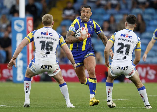 Warrington's Paul Vaughan, centre, runs at the Leeds defence at Elland Road