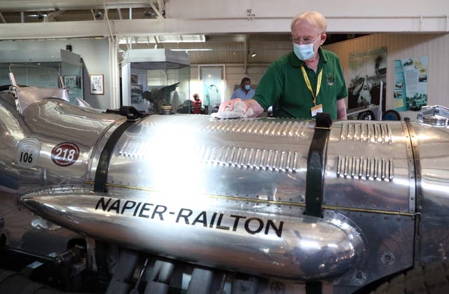 A volunteer polishes a Napier Railton (Andrew Matthews/PA)