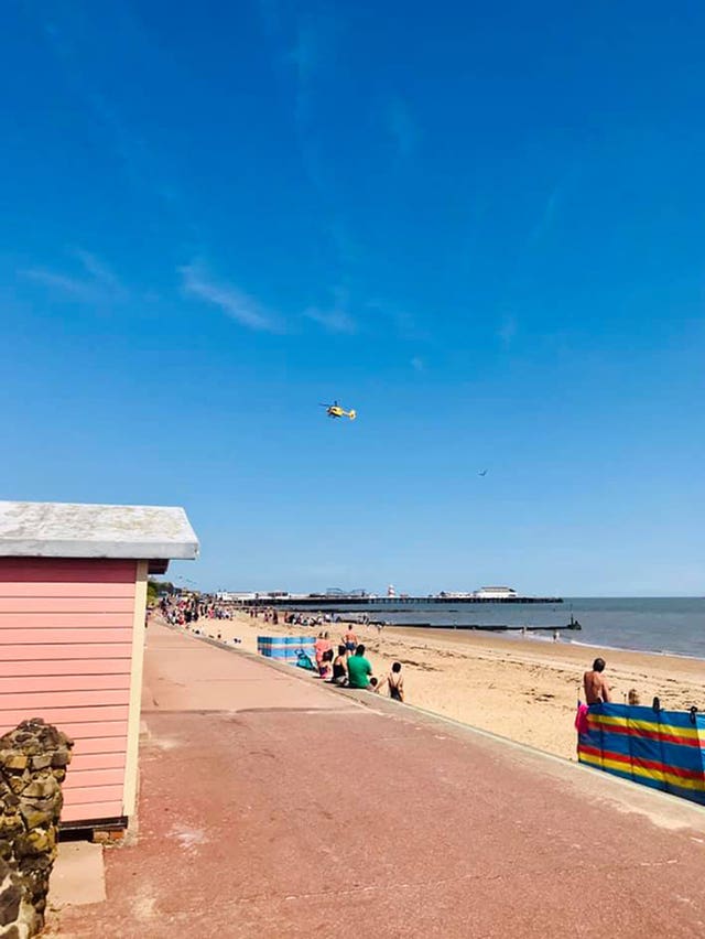 An emergency services helicopter above Clacton beach 