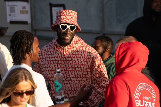 Stormzy watches D-Block Europe from the side of the stage at Glastonbury Festival