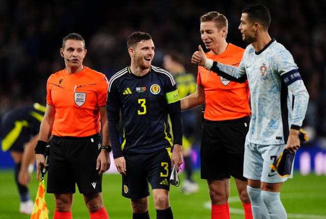 Cristiano Ronaldo gestures to officials and a Scotland player at Hampden Park