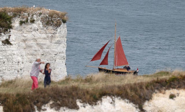 A sailing boat makes its way past Old Harry Rocks (Andrew Matthews/PA)