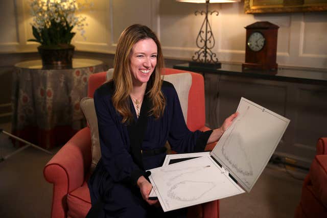 Clare Waight Keller holds sketches during an interview at Kensington Palace (Hannah McKay/PA)