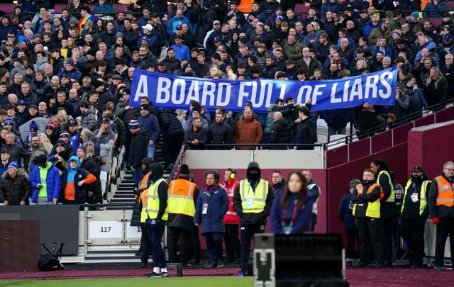 Everton fans hold up banners protesting against the board of directors