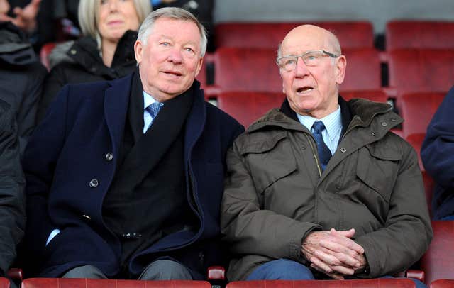 Charlton sitting alongside Sir Alex Ferguson  at Old Trafford (Martin Rickett/PA).