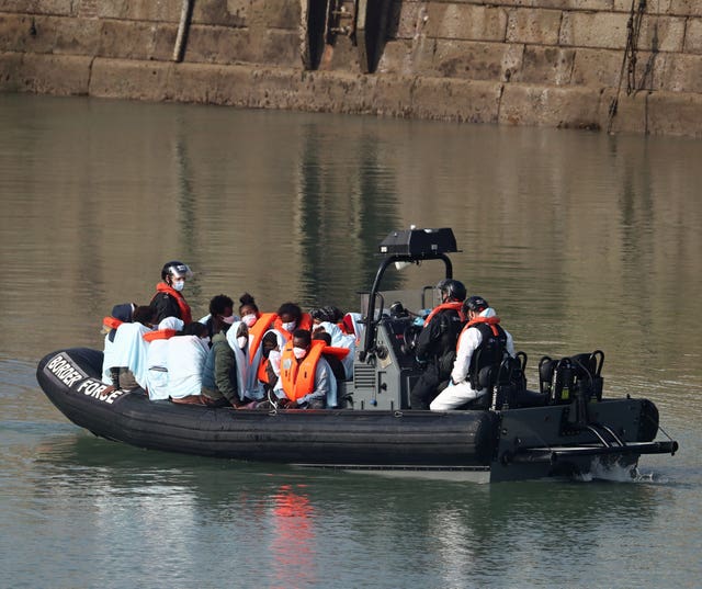 A group of people, thought to be migrants, are ferried ashore by Border Force officers at Dover marina in Kent 
