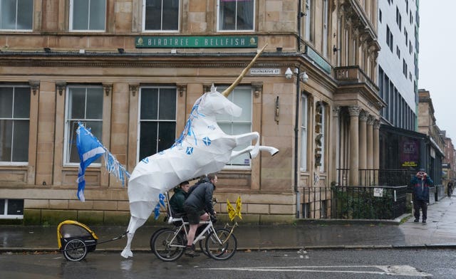 Protesters enroute to take part in the rally in Glasgow (Andrew Milligan/PA)