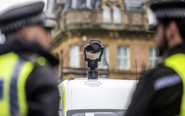 Police officers and a live facial recognition van
