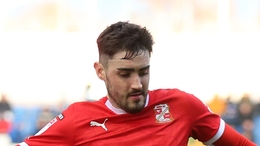 Stockport County�s Connor Lemonheigh Evans and Swindon Town�s Dawson Devoy during the Sky Bet League Two match at Edgeley Park, Stockport. Picture date: Saturday February 24, 2024.