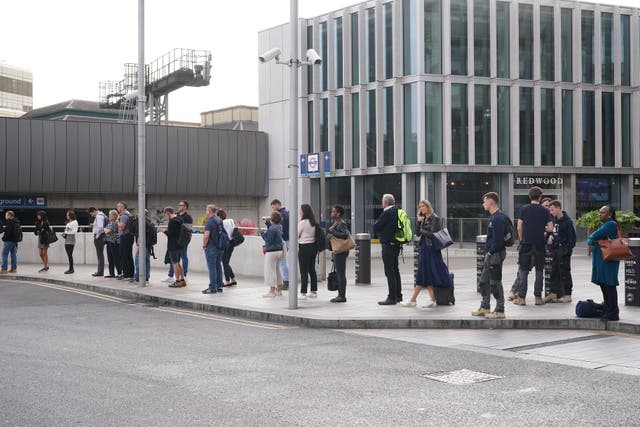 Commuters in a queue waiting for a bus at London Bridge station (Yui Mok/PA)
