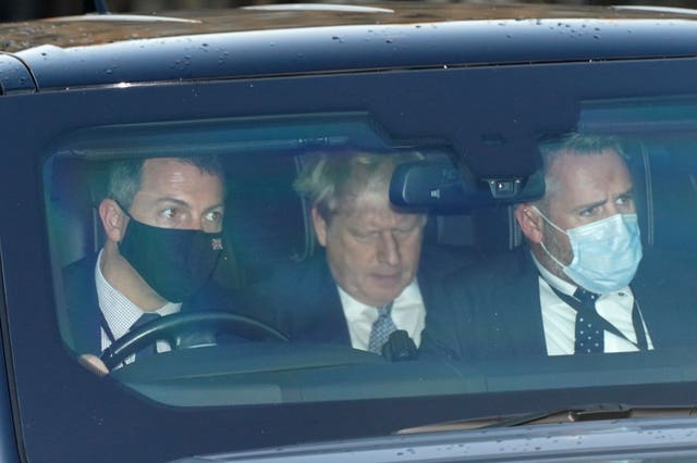 Prime Minister Boris Johnson leaves the Houses of Parliament in the back seat with his body guards.