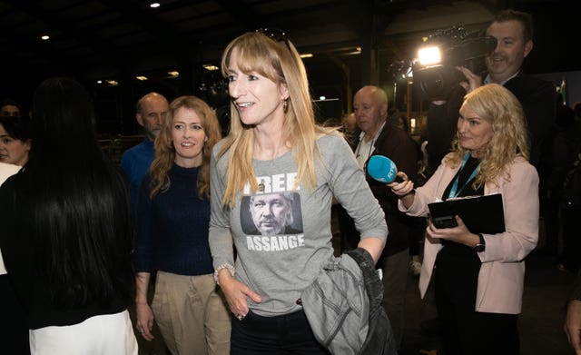 Independents 4 Change candidate Clare Daly, wearing a T-shirt saying 'Free Assange', on her way out of the count centre at the RDS in Dublin