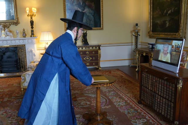 The QueenI appears on a screen via videolink from Windsor Castle, where she is in residence, during a virtual audience to receive the Ambassador from the Republic of Korea, Gunn Kim (Victoria Jones/PA)