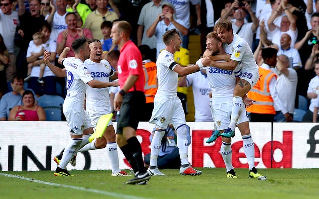 Liam Cooper, second right, celebrates scoring for Leeds in last season's opening win against Stoke