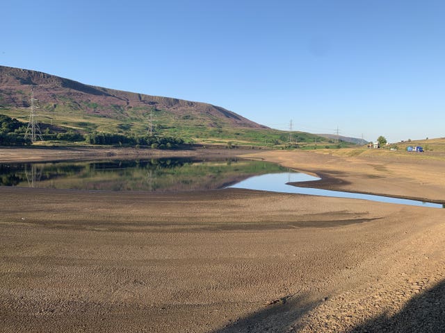 Bare earth and low water levels at reservoir in Derbyshire last summer
