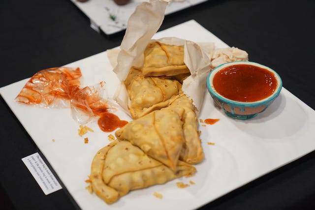 A cake depicting a selection of samosas and a dip