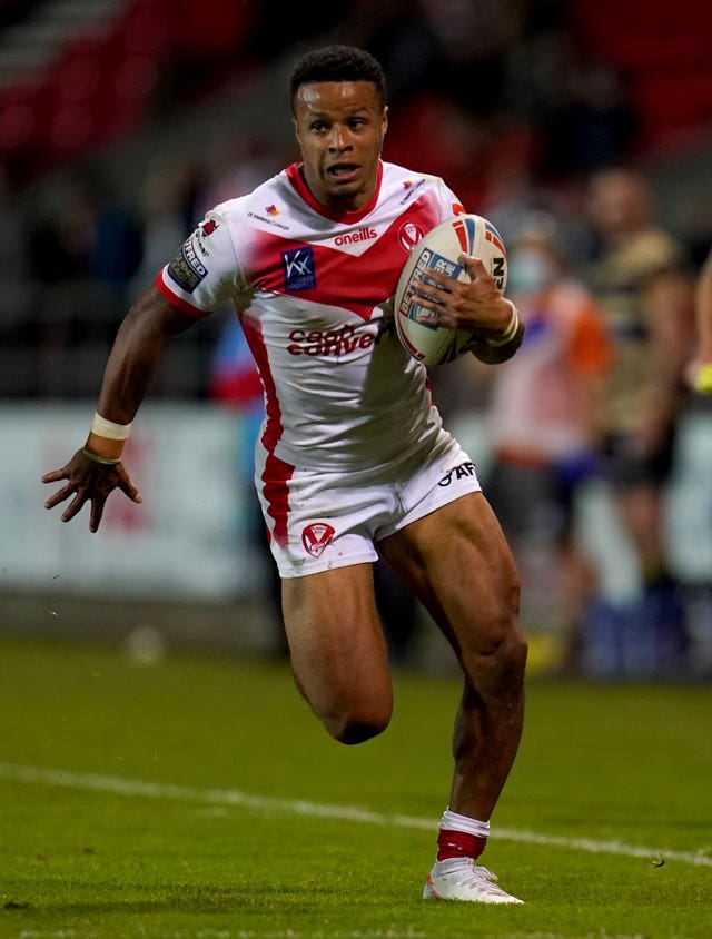 Regan Grace runs with ball in hand while playing for St Helens