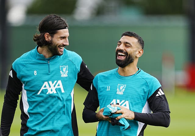 Liverpool’s Dominik Szoboszlai and Mohamed Salah share a joke in training