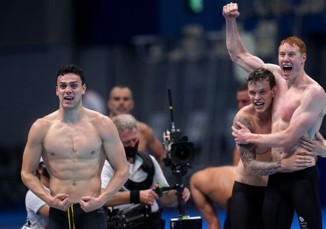 Dean celebrates with James Guy, left, and Matthew Richards after Scott anchored the team to victory