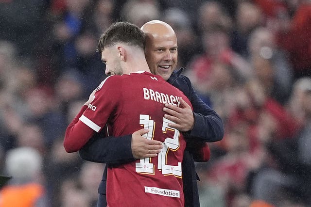 Liverpool manager Arne Slot embraces Conor Bradley after the Champions League win over Real Madrid