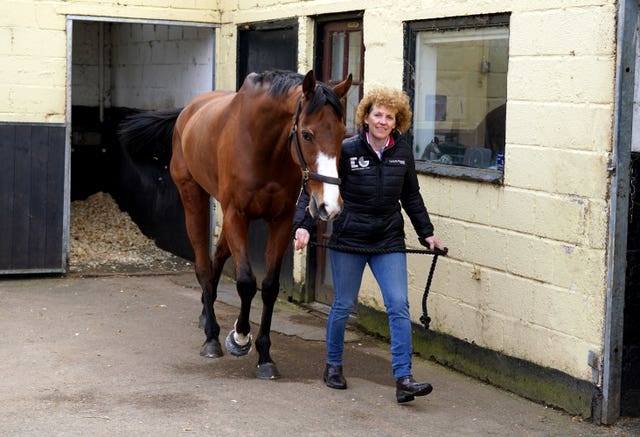 Lucinda Russell walks Corach Rambler through her yard 