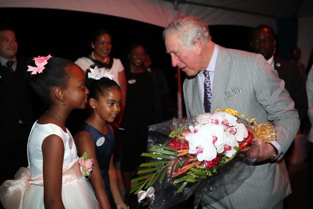 The Prince of Wales is presented with flowers as he attends the Governor-General’s Reception at the Serenity Hotel, Coconut Bay, St Lucia