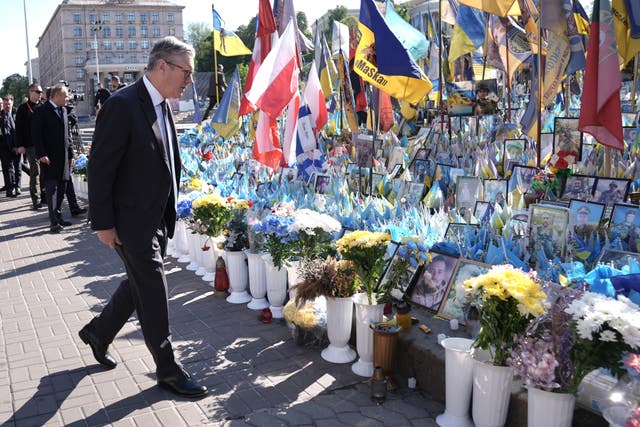 Prime Minister Sir Keir Starmer looking at tributes to fallen soldiers in Maidan Square