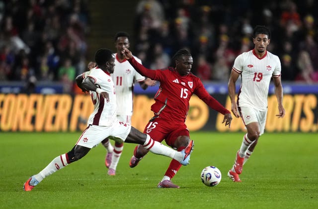 Canada’s Richie Laryea, Wales’ Ronan Kpakio, and Canada’s Nathan-Dylan Saliba (left-right) battle for the ball 