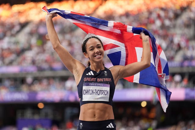 Katarina Johnson-Thompson holds the British flag aloft