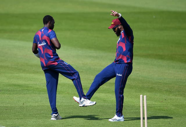 Marquino Mindley, left, celebrates the wicket of Jermaine Blackwood with John Campbell