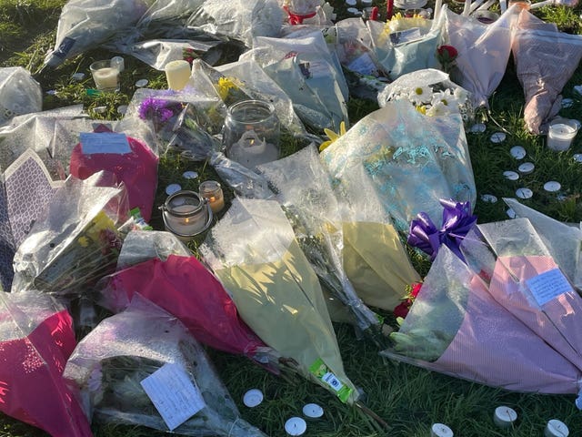 Floral tributes and candles laid at playing fields