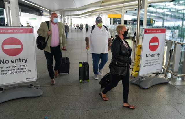 Charlotte Charles (right) and Tim Dunn (centre), the parents of Harry Dunn, with Family advisor Radd Seiger (left) arrive at Terminal 2 of Heathrow Airport