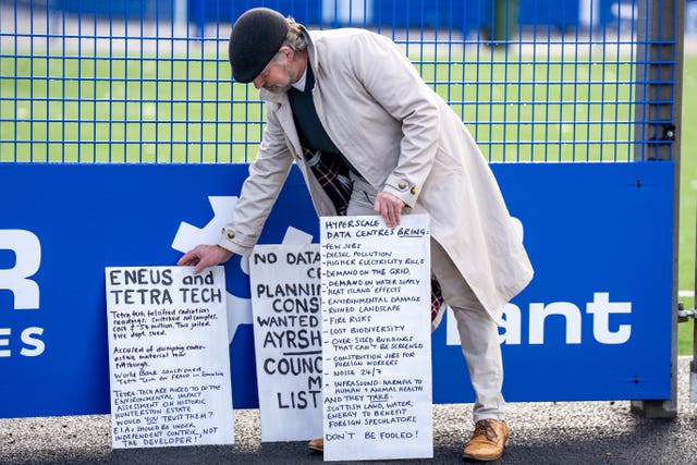 A protester places placards on the ground