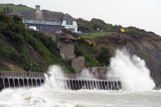 Waves crash over the promenade in Folkestone